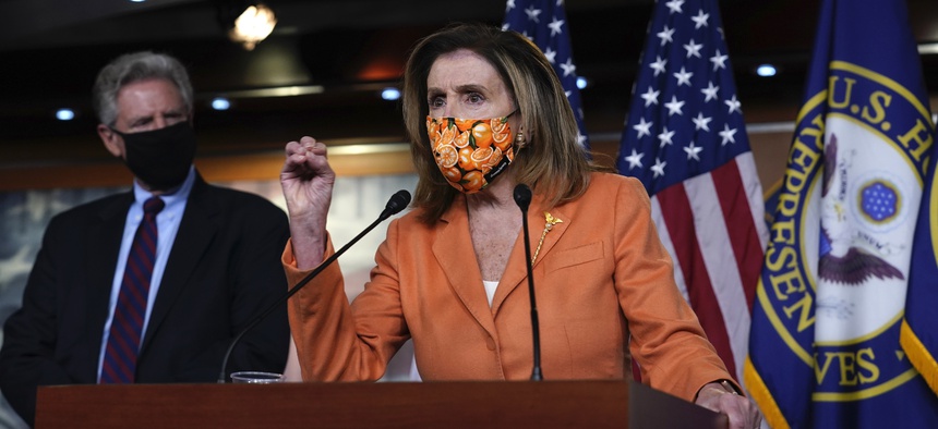 Rep. Frank Pallone, D-N.J., left, listens as Speaker of the House Nancy Pelosi, D-Calif., speaks with reporters at the Capitol in Washington, Thursday, Oct. 8, 2020.