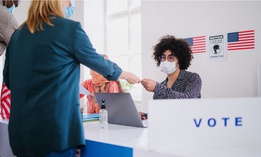 Poll watchers are allowed to watch election administrators as they help voters.