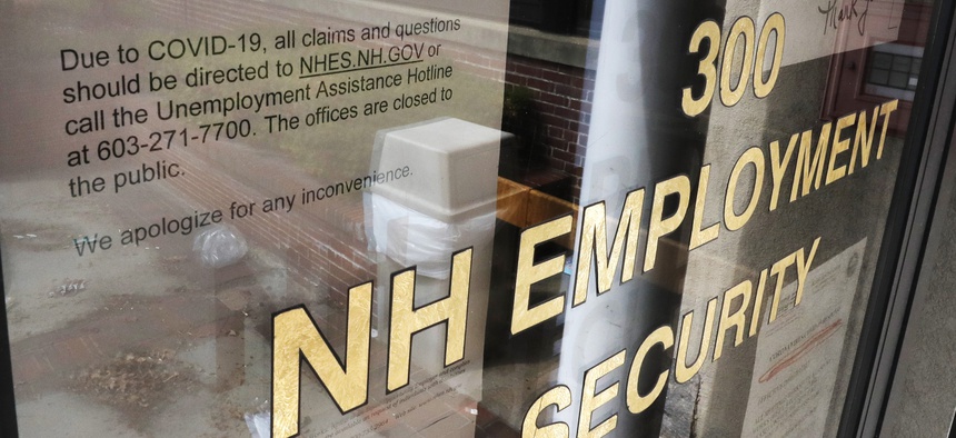 A note on a locked door at the New Hampshire Employee Security center, which handles unemployment claims, gives directions to those in need in Manchester, N.H., Thursday, April 16, 2020.