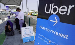 In this Aug. 20, 2020 photo travelers request an Uber ride at Los Angeles International Airport's LAX-it pick up terminal. Proposition 22 pitted the powerhouses of the so-called gig economy, including DoorDash, Postmates and Instacart, against labor union