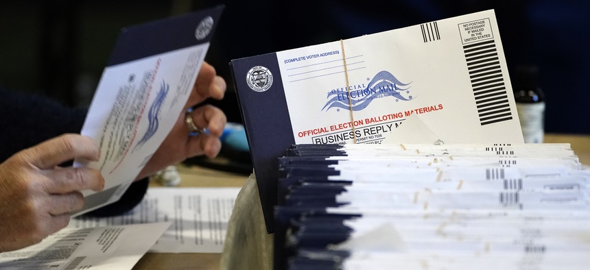Chester County, Pa. election workers process mail-in and absentee ballots at West Chester University, Wednesday, Nov. 4, 2020, in West Chester.