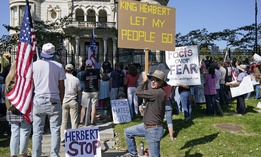 In this Sept. 12, 2020, file photo, people protest Gov. Gary Herbert during an anti-mask rally outside of the Governors Mansion in Salt Lake City. Protests have since spread to Herbert's private home in Orem, Utah.