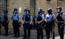 Minneapolis police stand near the Third Precinct in May. The department is under investigation by the state Human Rights Department.