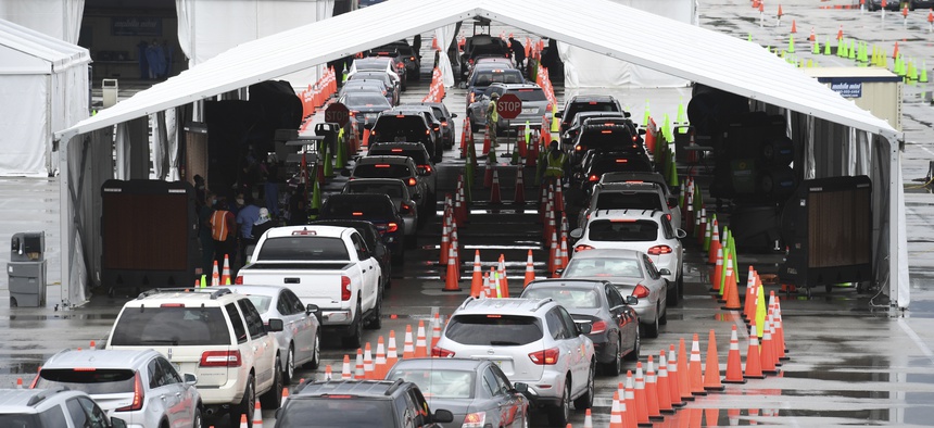 Cars wait in line at the Coronavirus (COVID-19) drive in testing site, set up in the parking lot of Hard Rock Stadium as Florida reported more than 5,838 new cases of COVID-19 on November 12, 2020 in Miami Gardens, Florida.