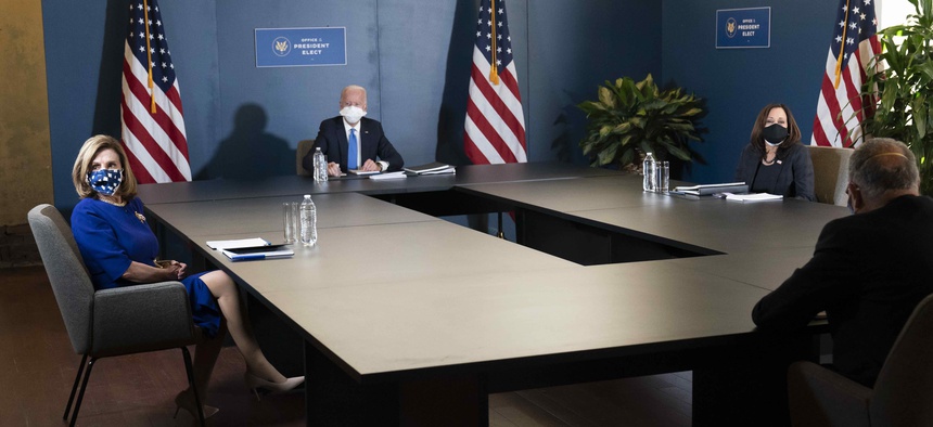 President-elect Joe Biden, speaks during a meeting with Vice President-elect Kamala Harris, right, Senate Minority Leader Chuck Schumer of N.Y., and House Speaker Nancy Pelosi of Calif., left, Friday, Nov. 20, 2020, in Wilmington, Del.