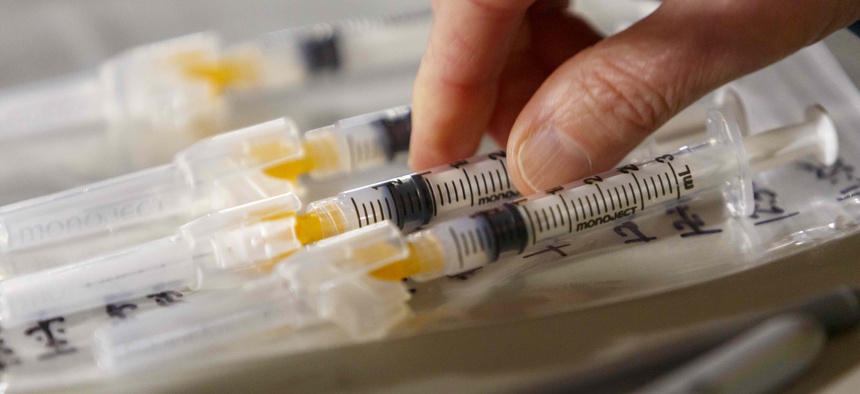 Home health care workers and their patients start receiving Moderna COVID-19 vaccines at a drive-thru vaccination clinic in Portland, Ore., Sunday, Jan. 10, 2021.