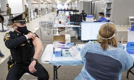 Sergeant Michael Zarro, of the Mount Olive, NJ, Police Department, rolls up his sleeve to receive a COVID-19 vaccination at one of the state's two vaccine megasites in Morris County, NJ on Friday, Jan. 8, 2021. 