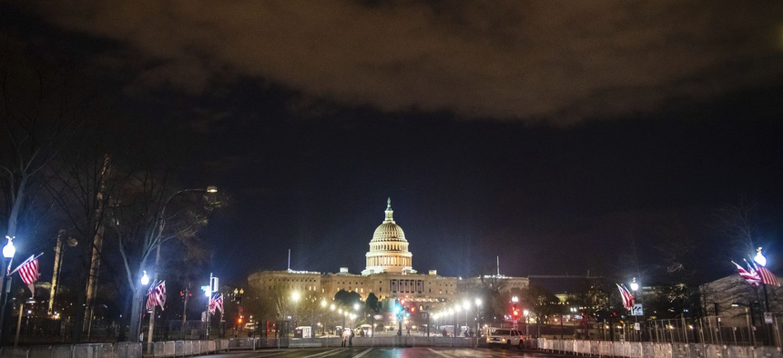 WASHINGTON D.C., JANUARY 17- A view of the Capitol Building surrounded by large fencing and protected by the National Guard before the United States Presidential Inauguration of Joe Biden on January 17, 2021 in Washington D.C.