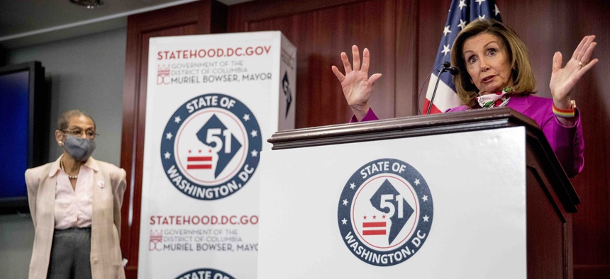 House Speaker Nancy Pelosi of Calif., right, accompanied by Delegate Eleanor Holmes Norton, D-D.C., left, speaks at a news conference on District of Columbia statehood on Capitol Hill, Tuesday, June 16, 2020, in Washington.