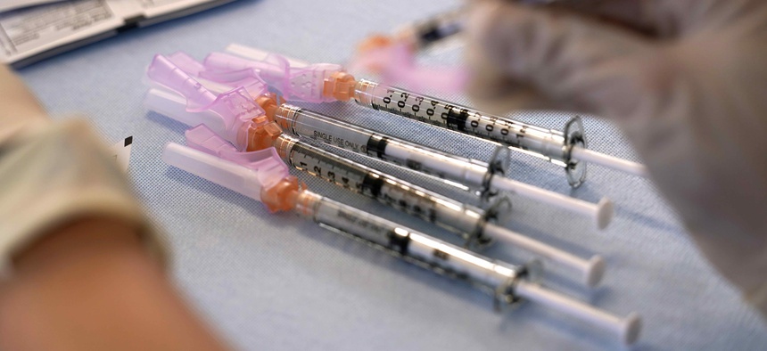 A worker readies syringes with the Moderna COVID-19 vaccine on March 29, 2021, at "Vaccine Fest," a 24-hour COVID-19 mass vaccination event in Metairie, La., just outside New Orleans, hosted by Ochsner Health System and the Jefferson Parish Government.